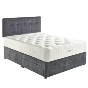 A detailed product image showing the internal layers of the Natural Luxury 1400 Deluxe mattress, including the pocket springs, foam, and natural fillings. The image also displays the full mattress on a divan base in a bedroom setting, highlighting its elegant finish and a tag with "10" indicating a 10-year warranty.