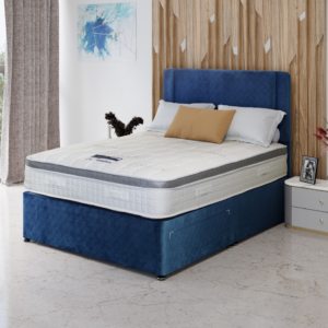 A close-up product image of the Kinetic mattress, showing its unique wavy quilted pattern and elegant white fabric. The design emphasizes a feeling of motion and support.