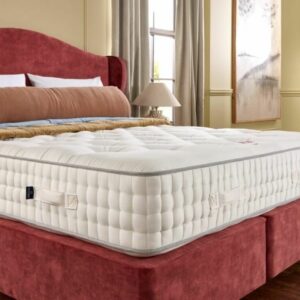 A screenshot of the Harrison Spinks Ruby 12,500 mattress product page. The images show a full mattress on a red divan base, a close-up of the mattress's quilting, and a list of key features including 12,500 springs and natural fillings.