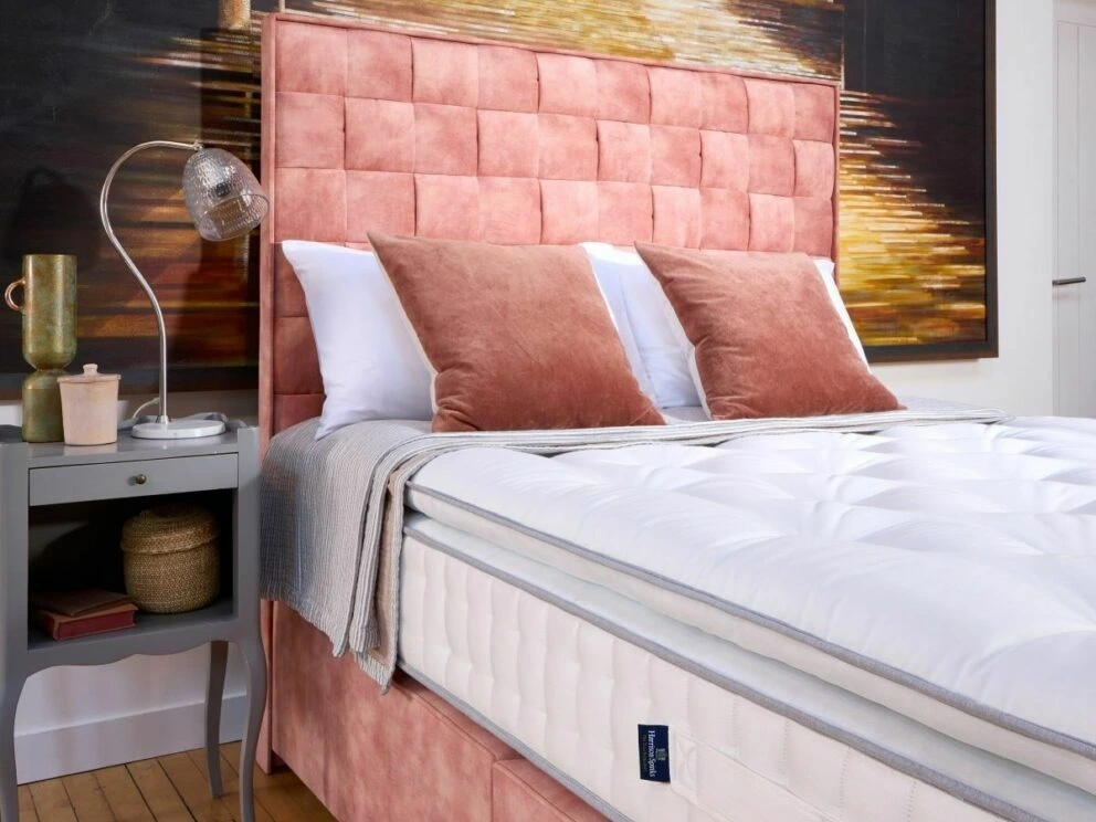 A screenshot of the Harrison Spinks Asscher Pillowtop 11,000 mattress product page. The images show a full mattress on a pink divan base, a close-up of the mattress's quilting, and a list of key features including 11,000 springs and natural fillings.
