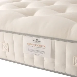 A screenshot of the Harrison Spinks Bronze 3,500 mattress product page. The images show a full mattress on a brown divan base, a close-up of the mattress's quilting, and a list of key features including 3,500 springs and natural fillings.