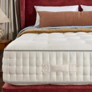 A screenshot of the Harrison Spinks Ruby 12,500 mattress product page. The images show a full mattress on a red divan base, a close-up of the mattress's quilting, and a list of key features including 12,500 springs and natural fillings.