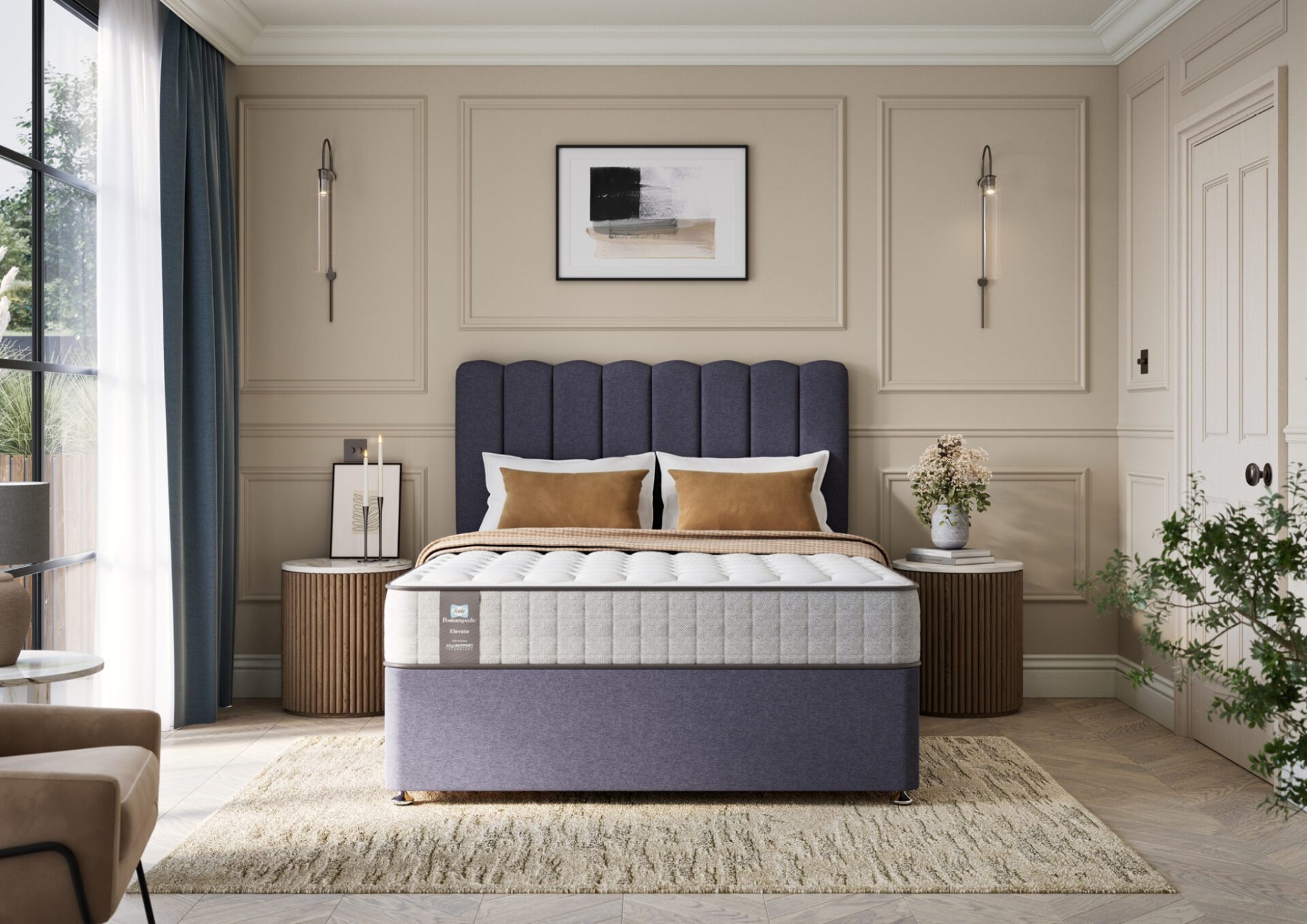 A full shot of the Chapman Extra Firm Mattress, shown on a matching divan base with a contemporary upholstered headboard. The mattress has a premium quilted white and grey top with the Sealy branding visible on the side panel.
