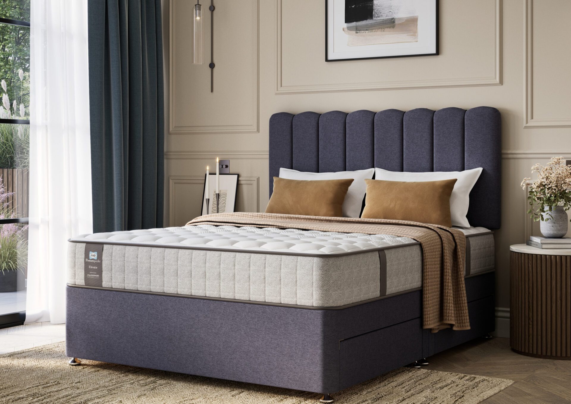A full shot of the Chapman Extra Firm Mattress, shown on a matching divan base with a contemporary upholstered headboard. The mattress has a premium quilted white and grey top with the Sealy branding visible on the side panel.