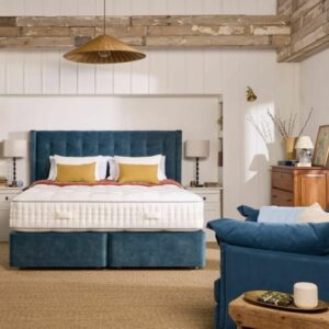 A screenshot of the Harrison Spinks Emerald 16,500 mattress product page. The images show a full mattress on a blue divan base, a close-up of the mattress's quilting, and a list of key features including 16,500 springs and natural fillings.