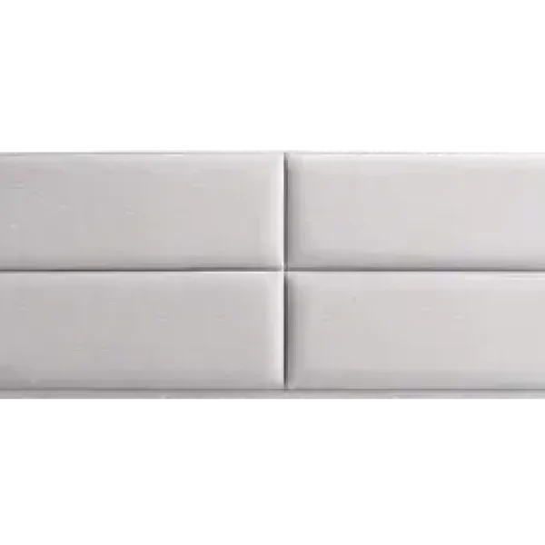 A white, upholstered headboard with a clean, timeless design featuring a cross that divides the surface into four panelled rectangles. The headboard is shown against a plain grey background.