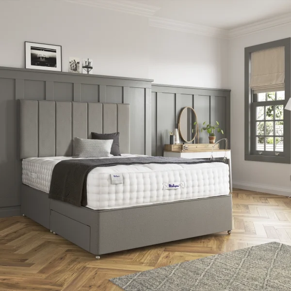 A detailed product image showing the internal layers of the Luxury Alpaca 2550 mattress, including the pocket springs and natural alpaca-wool layers. The image also displays the full mattress on a divan base in a bedroom setting, highlighting its hand-tufted finish and a tag with "10" indicating a 10-year warranty.