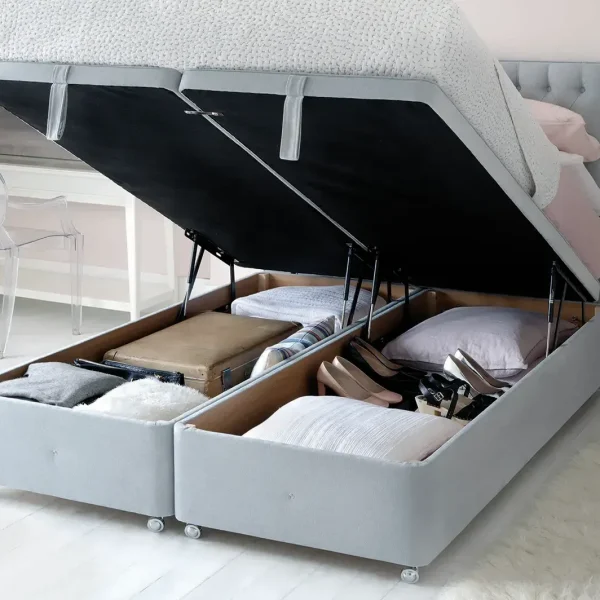 Two images of a Hypnos Superstorage™ divan base. The first image shows the divan base closed with a mattress on top in a bedroom setting. The second image shows the top of the bed base lifted up by hydraulic pistons to reveal a large, flexible storage space underneath, filled with pillows and blankets.