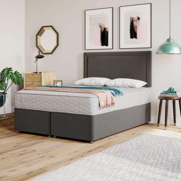 A screenshot of the Sealy Ottoman Divan Base product page. The image shows a bed with a Sealy mattress on a divan base with a headboard. A list of features including a full ottoman storage design, a StayTight™ lid fabric, and a 5-year guarantee is also visible.